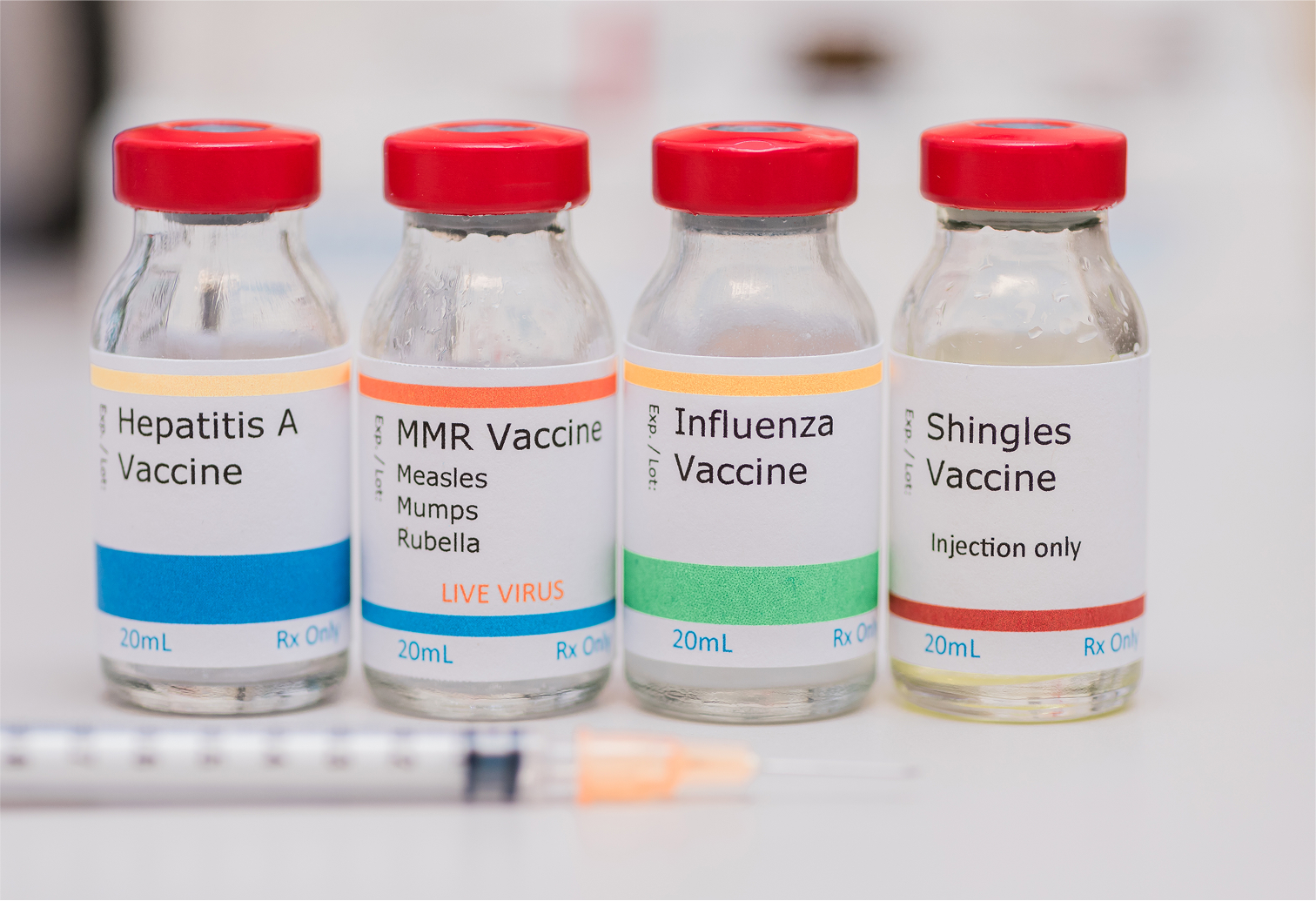 Healthcare worker administering shingles, influenza, MMR, or Hepatitis A vaccine via syringe injection into patient