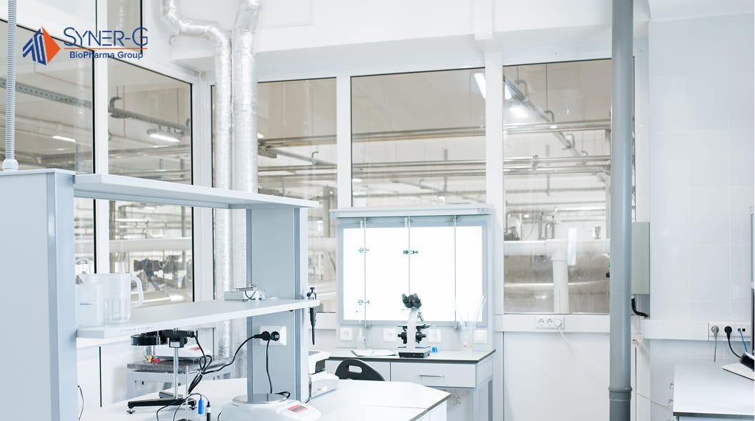 Modern pharmaceutical laboratory with clean equipment and workstations, representing GMP-compliant facility standards.