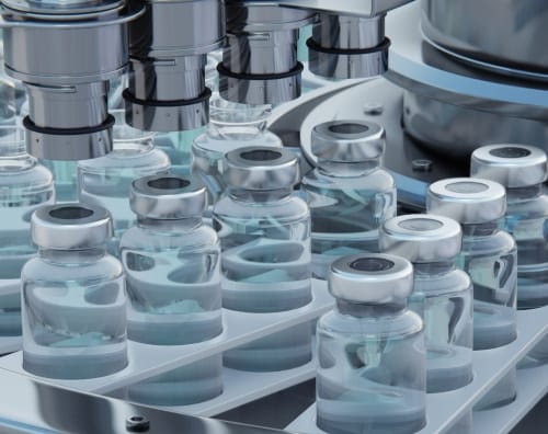 Biopharma manufacturing line filling glass vials in a pharmaceutical facility