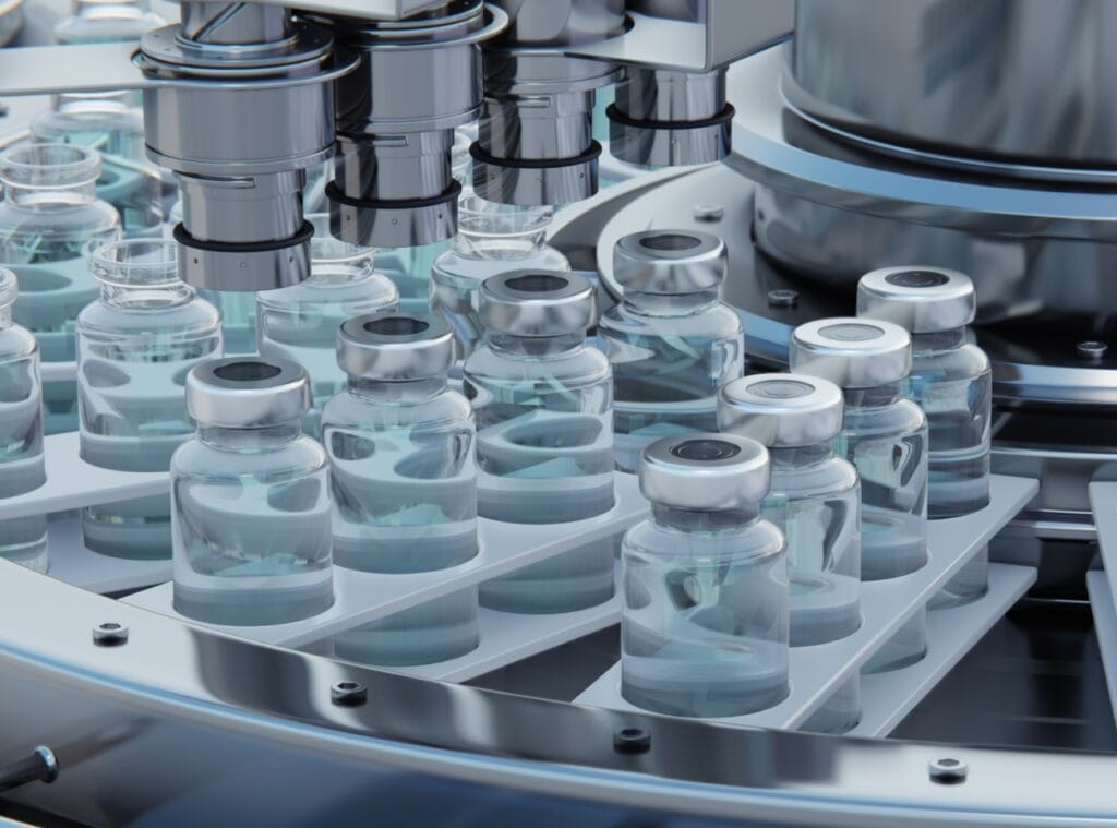Automated pharmaceutical manufacturing equipment processing biopharma vials