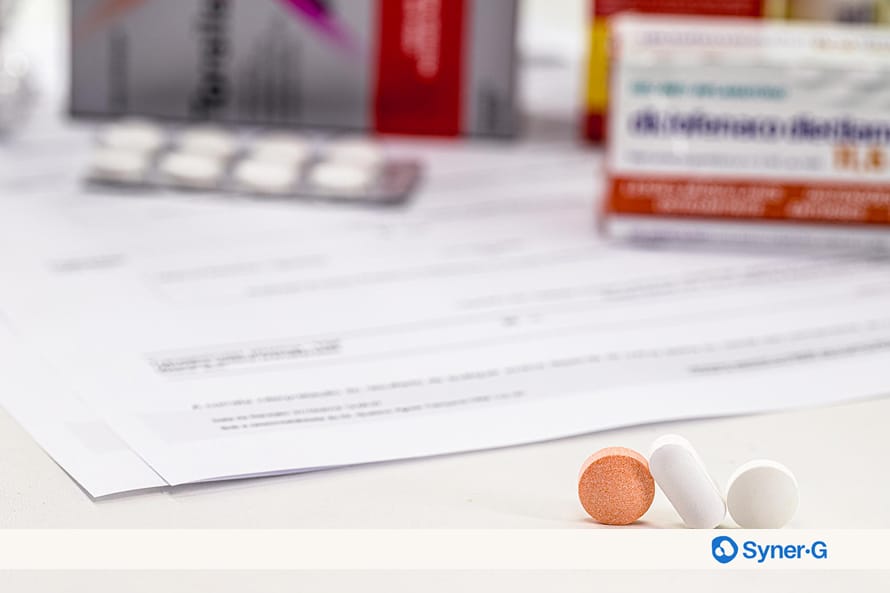 Pharmaceutical tablets shown alongside regulatory paperwork and packaged medication, reflecting CMC documentation, formulation review, and product quality evaluation.