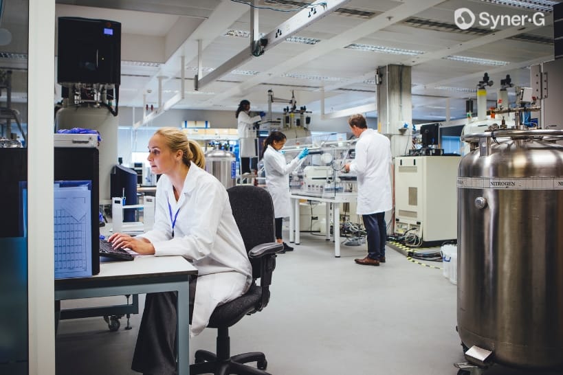 Biopharma team working in a laboratory to support a technology transfer execution plan and comparability protocol.